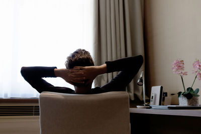 Man sitting on table at home