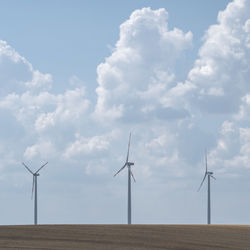 Windmill on field against sky