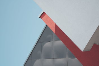 LOW ANGLE VIEW OF RED BUILDING AGAINST CLEAR SKY