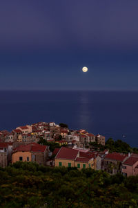 High angle view of townscape by sea against sky