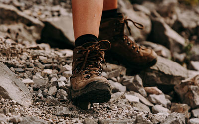 Low section of person with boots in rocky terrain