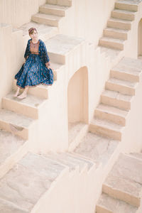 Woman sitting on staircase
