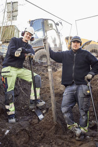 Portrait of confident construction workers at site