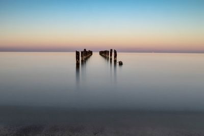 Scenic view of sea against clear sky during sunset