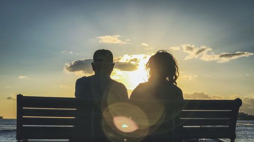 Men against sky during sunset