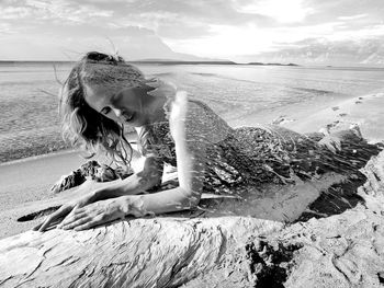 Woman on beach against sky