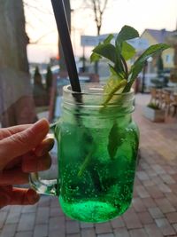 Close-up of hand holding glass of drink