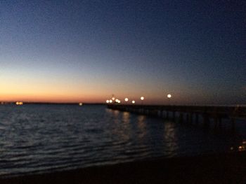 Scenic view of sea against clear sky at night