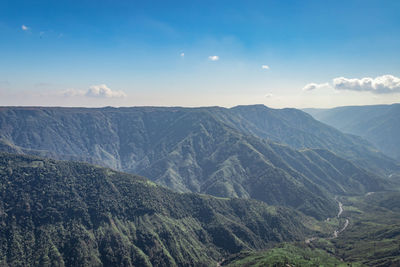 Misty mountain range covered with white mist and amazing blue sky