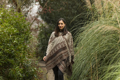 Portrait of smiling young woman standing on land