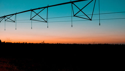 Scenic view of silhouette field against clear sky at sunset