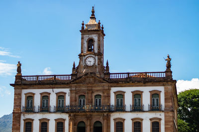 Low angle view of historic building against blue sky