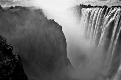 Scenic view of waterfall against sky