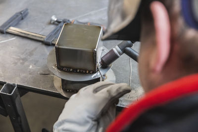 Cropped image of man repairing car