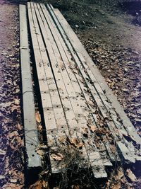 High angle view of abandoned bench on field