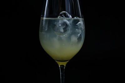 Close-up of beer glass against black background