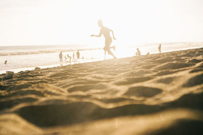 People on beach against sky