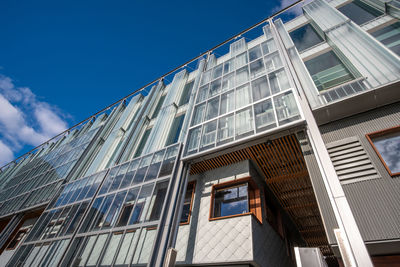 Low angle view of modern building against clear blue sky