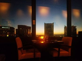 Illuminated cityscape against sky at night