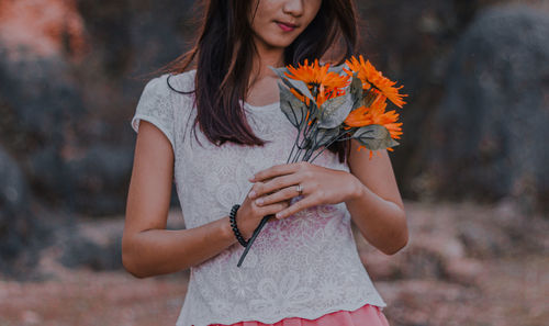 Young woman holding flower