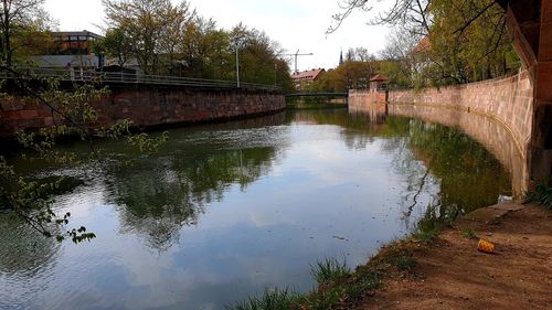 Bridge over canal against sky