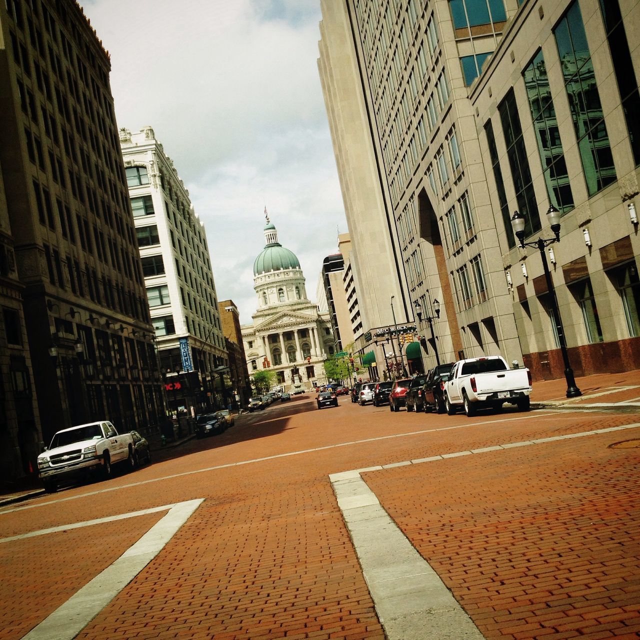 building exterior, architecture, built structure, city, street, car, transportation, road, sky, city street, the way forward, road marking, city life, incidental people, land vehicle, travel destinations, building, travel, tower, capital cities