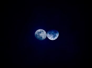 Low angle view of moon against blue sky