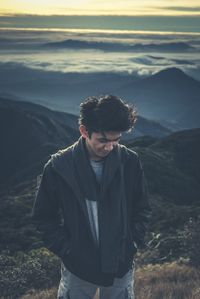 Young man standing on mountain landscape