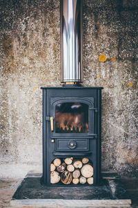 Wood burning stove against wall at home