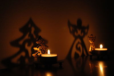 Close-up of illuminated candles on table