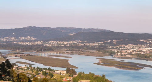 High angle view of river amidst buildings against sky