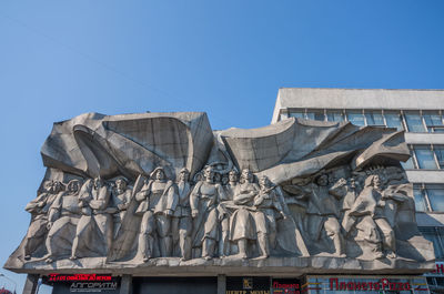 Low angle view of statue against clear blue sky