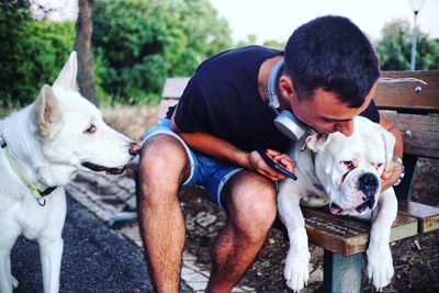 Close-up of dog looking at man embracing pet