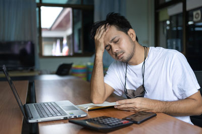 Man sitting on table at home