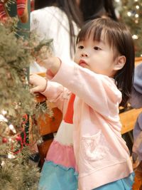 Cute girl holding christmas tree