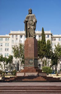 Statue in front of building