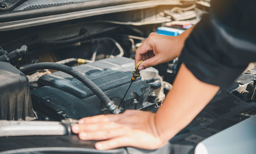 Midsection of man working in car