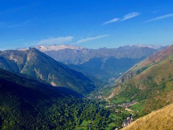 Scenic view of mountains against blue sky