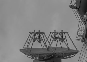 Close-up of communications tower against sky