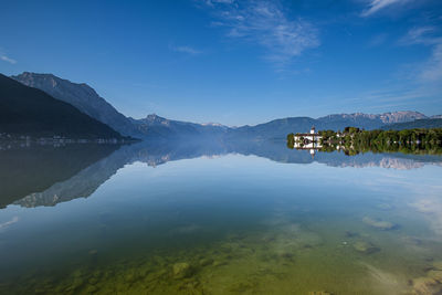 Scenic view of lake against blue sky