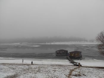 Two houses on the frozen river and two children