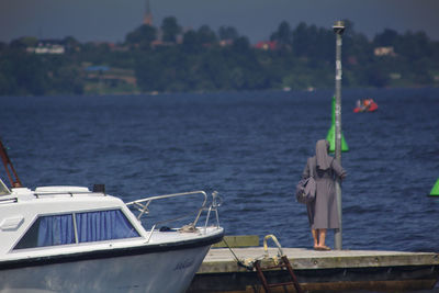 Man in sea against sky
