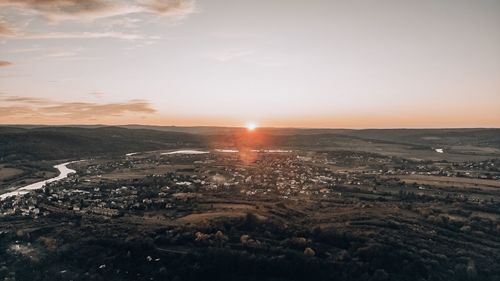 Scenic view of city against sky during sunset