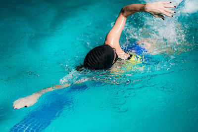 Woman swimming in pool during competition