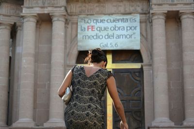 Close-up of woman standing on sidewalk