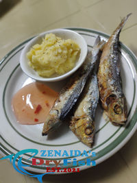 High angle view of fish in plate on table