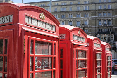 Telephone booth against buildings in city