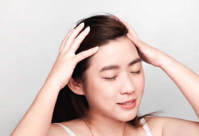 Close-up portrait of a beautiful young woman over white background