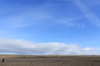 Scenic view of desert against blue sky