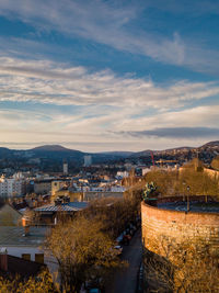 High angle view of townscape by river against sky